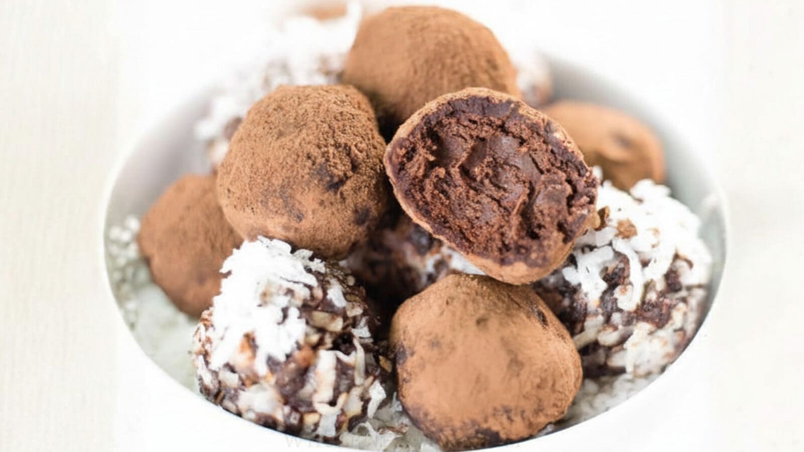 chocolate avocado truffles in white bowl.