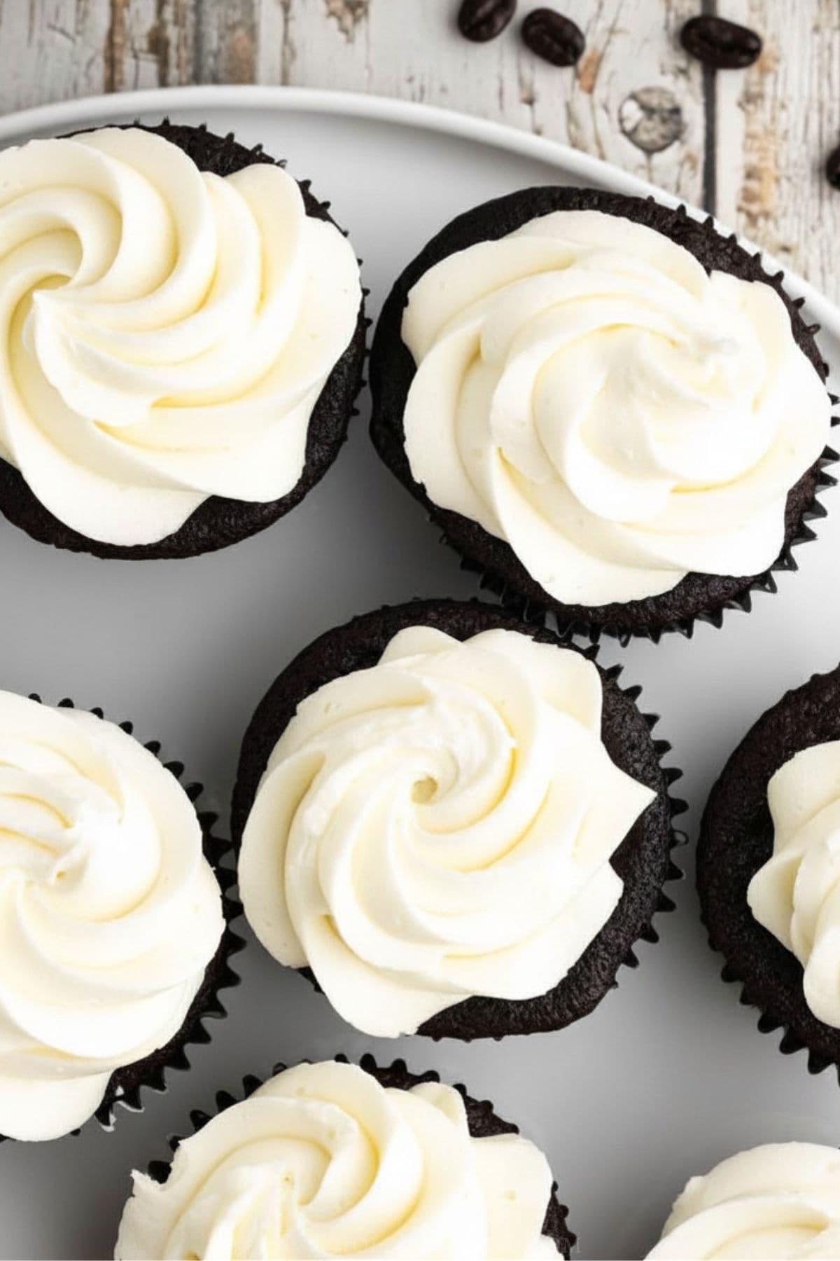 overhead view of keto buttercream frosting on gluten free chocolate cupcakes.