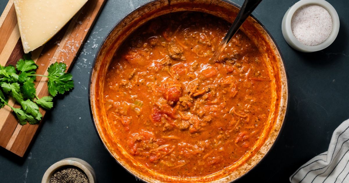 Dutch oven filled with healthy beef bolognese sauce.